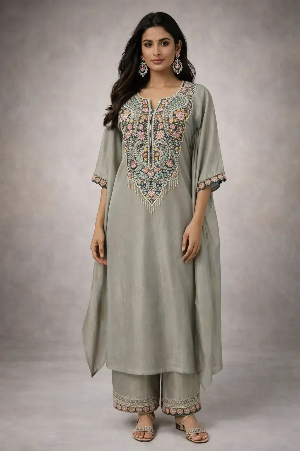 Woman in grey embroidered ethnic kurta set with floral details, matching pants, and dupatta