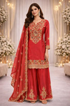 Woman wearing red embroidered Anarkali suit with dupatta, ideal for weddings and festive occasions