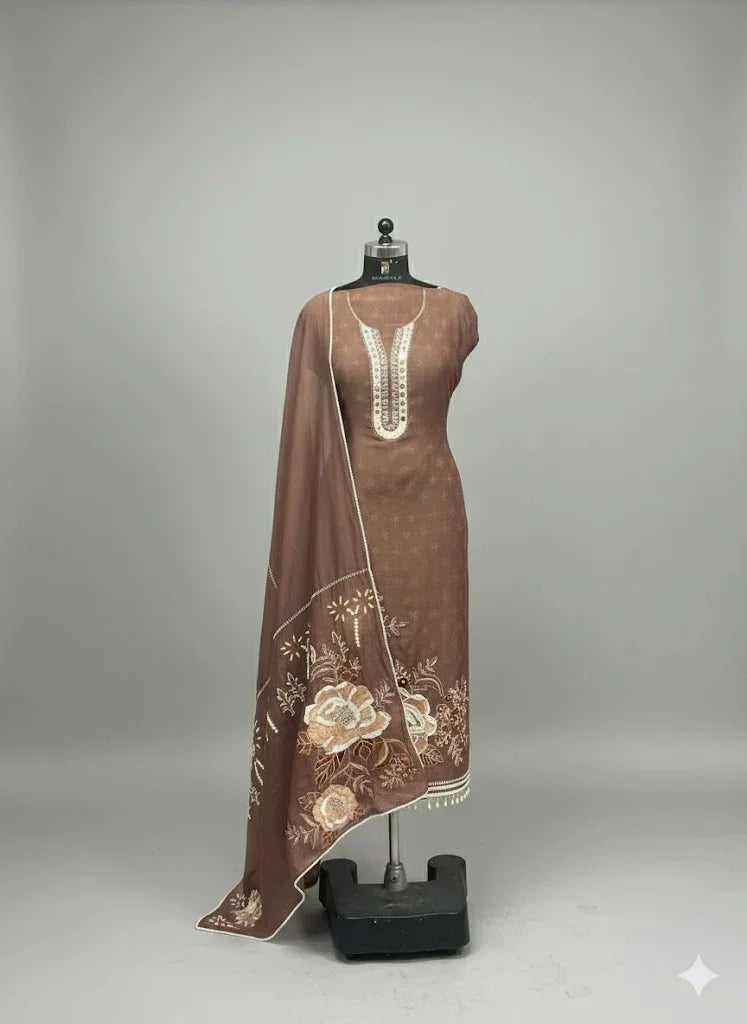 Brown ethnic salwar kameez set with floral embroidery and matching dupatta on mannequin